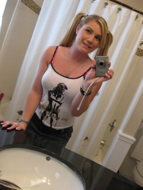 Blonde gf Hayden Night snaps selfies in bathroom while licking a lollipop