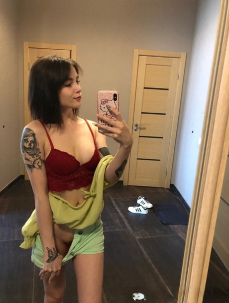 Slender amateur brunette strips and poses naked in front of the mirror