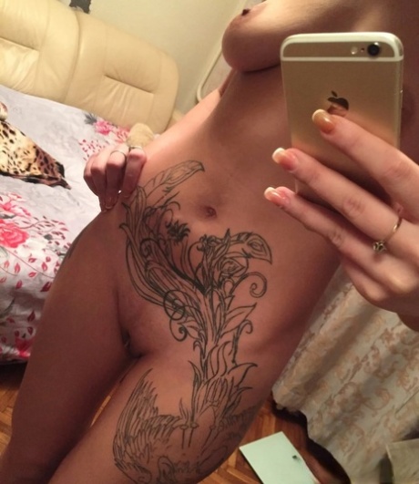 Tattooed amateur shows off her big ass & her small tits while taking nudes