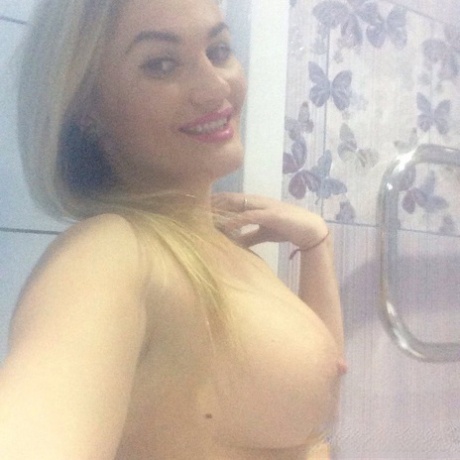 Blonde amateur shows off her juicy breasts & pussy while taking nude selfies