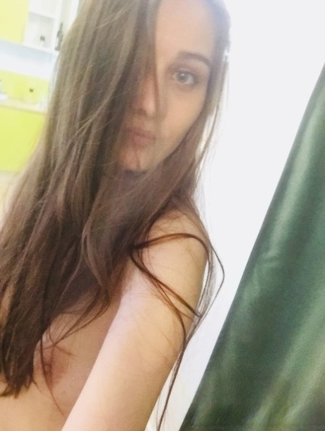 Dark-haired honey poses naked and in her sexy lingerie in the mirror