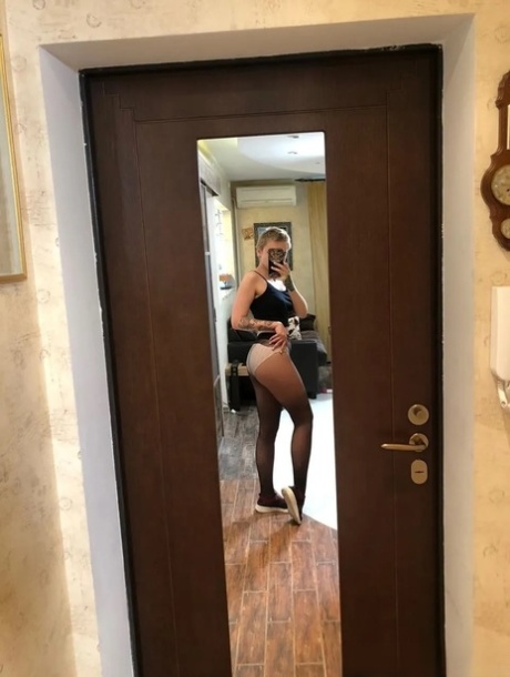 Sexy cheerleader takes nude selfies showing her small tits & her hot ass