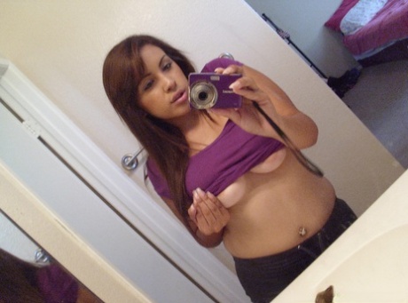 Solo girl Jeanette takes self shots in a mirror of her great boobs