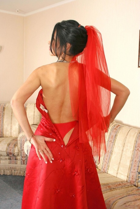 Mature Latina Nelli strips and displays her big booty and stockinged feet