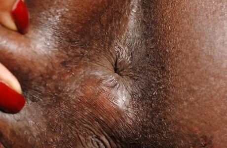 Cute ebony babe Jasmine pours a lot of oil into her anal hole