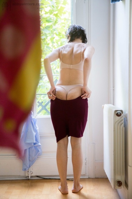 Natural female covers her hairy bush with panties as she gets dressed