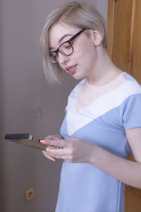 Nerdy young adult with blonde hair Abby exposes her bushy clam in a solo